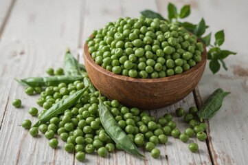 Healthy green peas with pods and leaves in a rustic wooden bowl on a white table