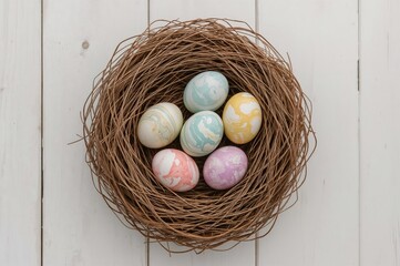 Obraz premium Trendy contemporary Easter eggs with vibrant marble patterns resting in a cozy wool nest on a white wooden surface with space for writing