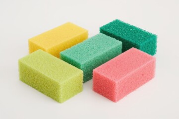 Set of five colorful cellulose kitchen sponges on a white background