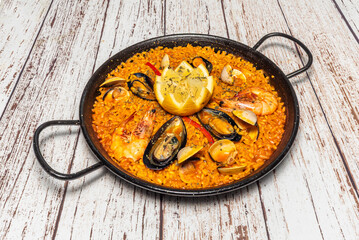 Mixed paella combining seafood and meat, with perfectly cooked bomba rice that absorbed all the flavors of the broth