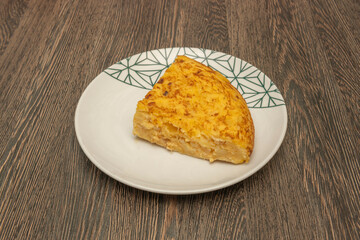Potato omelet served with a green salad, creating a fresh contrast with the richness of the omelet