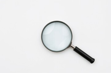 Empty magnifying glass on top of a newspaper with ample space for your text