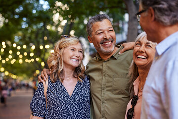 Mature women and men laughing together