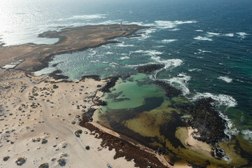 Aerial View of Los Charcos Beach with Stone Wind Shelters