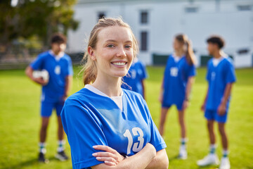 Naklejka na ściany i meble Young athlete girl smiling at football field
