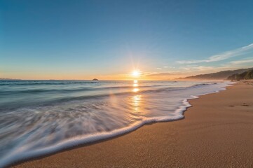 Sunrise viewed from a coastal beach with the ocean