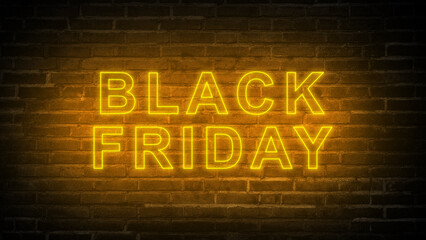 Obraz premium Closeup view of golden neon light text of Black Friday on a black brick wall background. Copy space. Black Friday sale concept