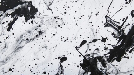 Black ink splashes and blots on a white paper create an abstract background