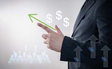 Business growth and financial success concept with businessman pointing at upward green arrow,...