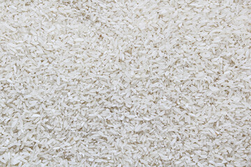 A pile of uncooked white rice grains, showcasing their texture and pattern.