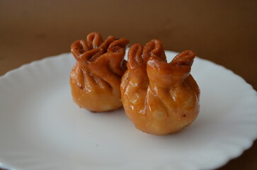 Traditional Indian sweet dry fruit potli . A festive mithai made by filling dry fruits in a crispy fried pastry, then dipped in sugar syrup for a rich, crunchy, and sweet taste.