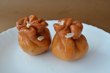 Traditional Indian sweet dry fruit potli . A festive mithai made by filling dry fruits in a crispy fried pastry, then dipped in sugar syrup for a rich, crunchy, and sweet taste.