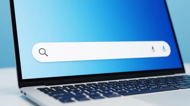 Laptop Displaying Search Bar on a Blue Screen with Sleek Design and Modern Aesthetics