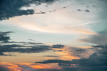 Tranquil beauty of a sunset sky, with a stunning array of vibrant colors and dramatic cloud...