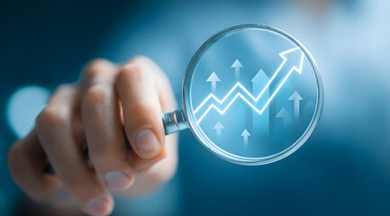 Magnifying glass shows an upward trend chart