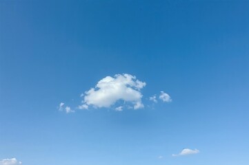 Azure sky featuring scattered clouds and a single white cloud