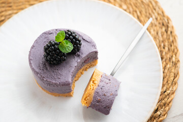 Blackberry mousse tart with a biscuit base. Traditional French recipe.