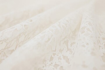 Obraz premium Delicate white lace with a soft blur effect, featuring an intricate mesh pattern that offers a light and elegant texture, perfect for vintage-style creations.