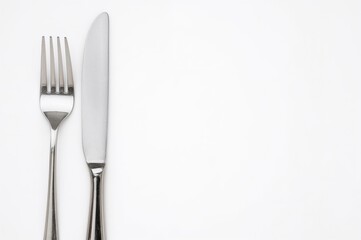 Cutlery set including a fork and knife on a plain white backdrop