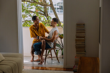 LGBTQ partners sharing an intimate morning on the balcony