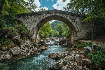 An ancient stone archway spanning a gentle river surrounded by lush greenery