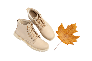 Neutral colored combat boots with autumn leaf accent for seasonal fashion styling, isolated on a transparent background