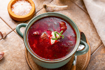 Traditional Ukrainian beet soup - borscht on the table close up