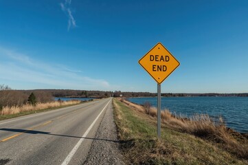 Road Closure Sign at the Shoreline Terminus of a River in a Small Town Setting