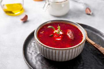 Traditional Ukrainian beet soup - borscht on the light background close up