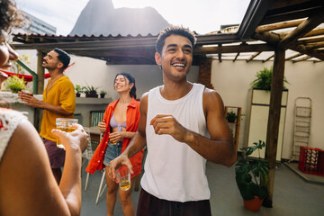 Young adults enjoying a rooftop gathering in Rio de Janeiro under sunlight
