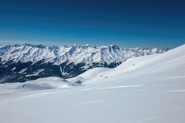 Snow-covered mountain summits and pristine, untouched ski paths