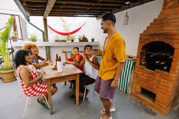 Friends gathering for a barbecue on a sunny summer afternoon