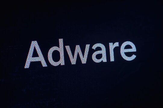 Malicious software highlighted on a monitor surrounded by binary digits in a tilted view with a retro filter.