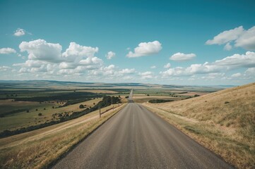 Naklejka premium Aerial view of a highway cutting across flat grasslands in a wide-angle panorama