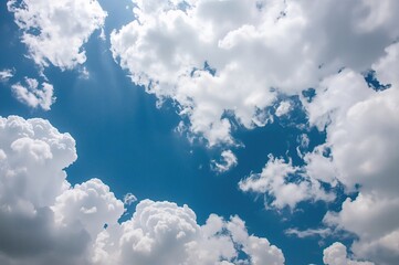 Nature-inspired abstract backdrop featuring white clouds against a blue sky