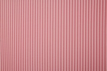 Obraz premium Close-up of pink velour corduroy fabric with prominent ribbed texture