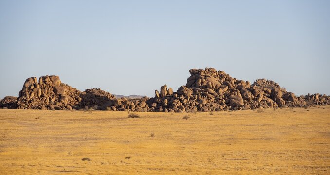 Barren landscape with hills of stacked rocks, desert landscape in the evening light at sunset, Erongo, Damaraland, Namibia