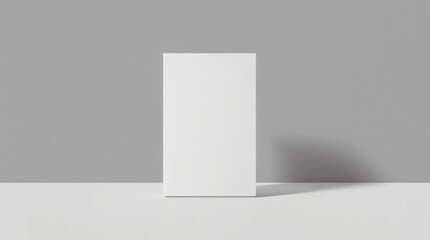Vertical standing blank white flyer or card mockup positioned against a soft two-tone grey background