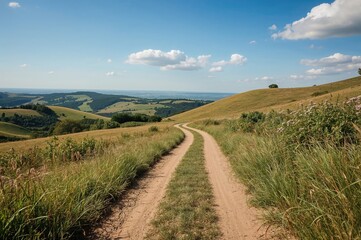 Fototapeta premium Unpaved trail winding through hilly terrain near urban areas