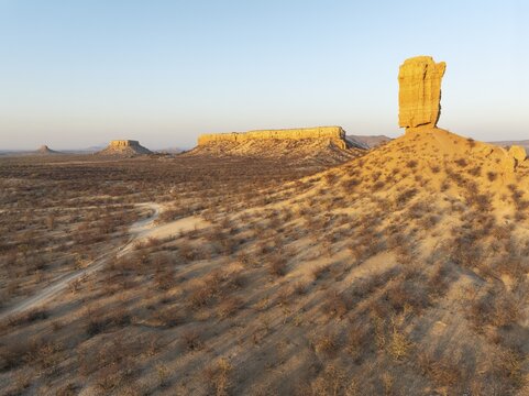 The Vingerklip (rock finger) and the Ugab Valley Terraces are surrounded by thornbush and mopane (Colophospermum mopane) savanna. Aerial view. Drone shot. Damaraland, Namibia