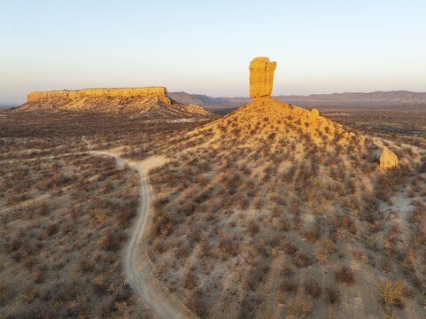 The Vingerklip (rock finger) and the Ugab Valley Terraces are surrounded by thornbush and mopane (Colophospermum mopane) savanna. Aerial view. Drone shot. Damaraland, Namibia