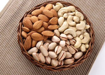 Indian dry fruits Kju, Badam and Pista in basket isolated