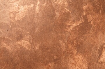 Copper panel with natural lighting effects, featuring scratches and fingerprints