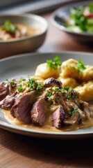 A plate of Czech svíčková, showing tender roasted beef topped with creamy sauce, garnished with cranberry
