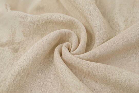 Close-up of textured beige muslin cloth with wrinkles
