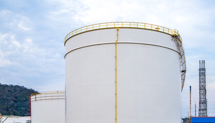 Crude Oil Industry, White Storage Fuel Gas Container Tanks in Petroleum Refinery Industrial Factory area against Blue Sky Background