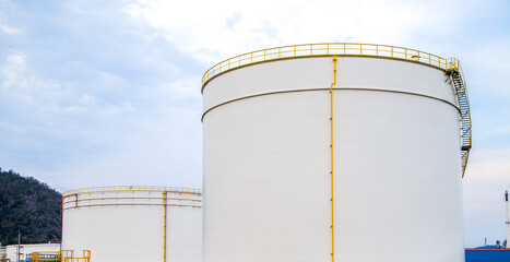 Crude Oil Industry, White Storage Fuel Gas Container Tanks in Petroleum Refinery Industrial Factory area against Blue Sky Background