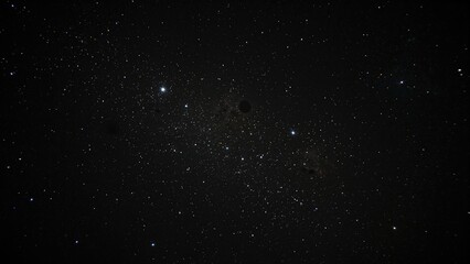 Fototapeta premium Stars scattered across a dark sky, showcasing a universe filled with nebulae and galaxies captured with long exposure and precise white balance, highlighting incredible focus and detail.