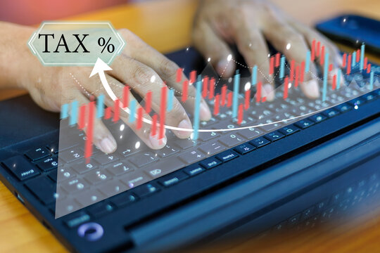 A human holds a glowing Earth globe, symbolizing global business and interconnectedness, overlaid with a dynamic upward-trending financial graph, a tax, and a digital coin - Powered by Adobe