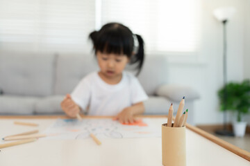 Naklejka premium Happy Asia children playing learning paint on paper. Activity, development, IQ, EQ, meditation, brain, muscles, essential skills, family having fun spending time together. Holiday